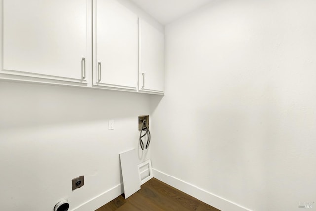 washroom with hookup for a washing machine, hookup for an electric dryer, dark wood-style flooring, baseboards, and cabinet space