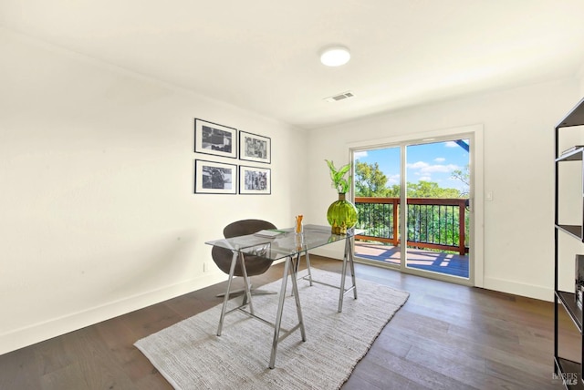 home office featuring dark wood-style flooring, visible vents, and baseboards