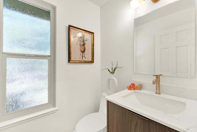 bathroom featuring toilet and vanity