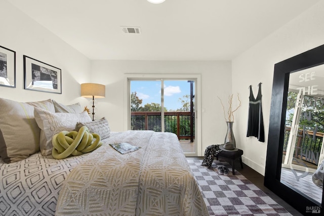 bedroom featuring access to outside, baseboards, and visible vents