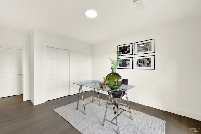 home office with visible vents, baseboards, and dark wood-style flooring