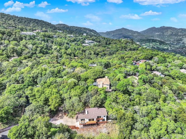 drone / aerial view with a mountain view and a forest view