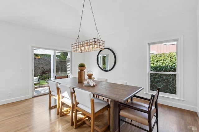 dining room featuring baseboards and light wood-style floors