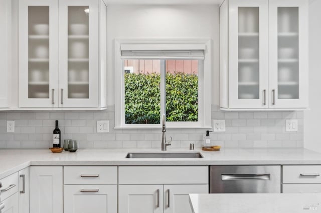 kitchen with a sink, white cabinetry, and light countertops