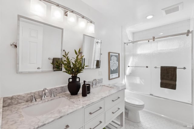 full bath featuring double vanity, toilet, visible vents, and a sink