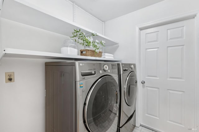 clothes washing area with washing machine and dryer and laundry area