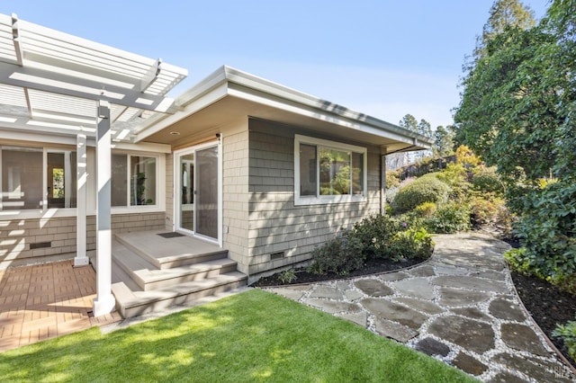 view of side of property with crawl space, a patio, a yard, and a pergola