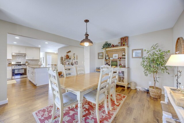 dining space featuring recessed lighting and light wood-style floors