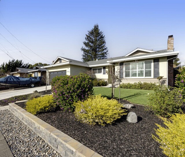 single story home featuring stucco siding, driveway, a front lawn, an attached garage, and a chimney