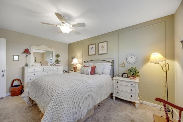 bedroom featuring light carpet, a ceiling fan, and baseboards