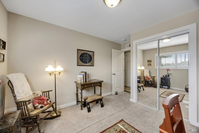 sitting room featuring carpet flooring and baseboards