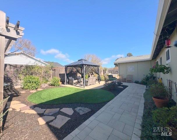 view of yard with a gazebo, a patio area, and fence