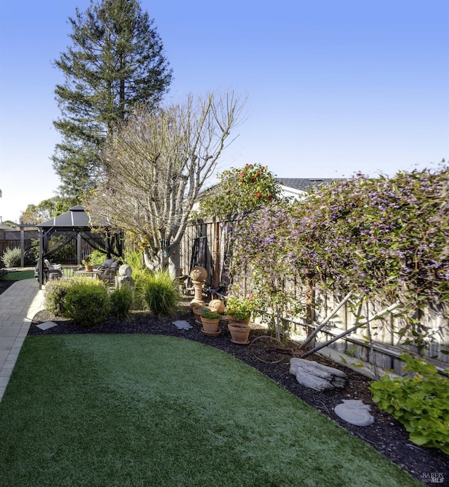 view of yard with a gazebo and a fenced backyard