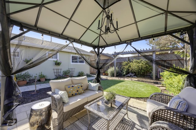 view of patio / terrace featuring a gazebo, fence, and an outdoor hangout area