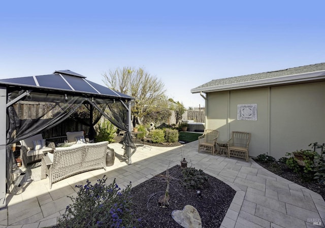 view of patio featuring a gazebo and fence