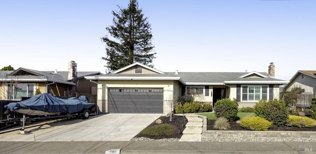 single story home with stucco siding, concrete driveway, and a garage