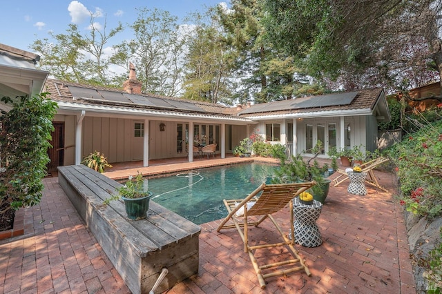 pool with a patio and french doors