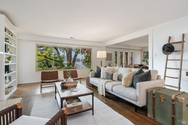 living area with wood finished floors and visible vents