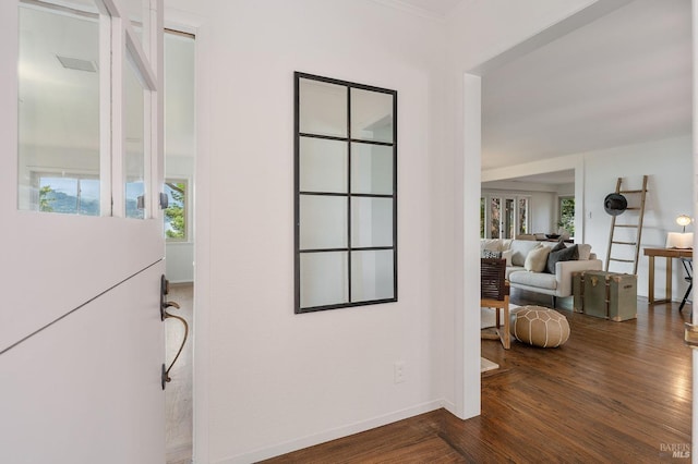 corridor with baseboards and dark wood-style floors