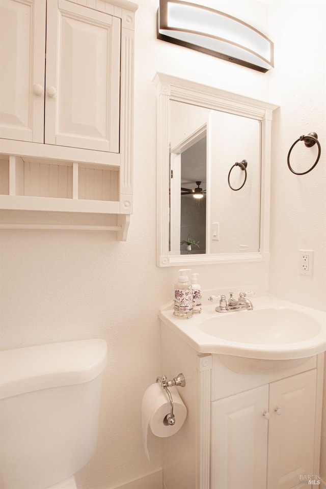 bathroom with toilet and vanity