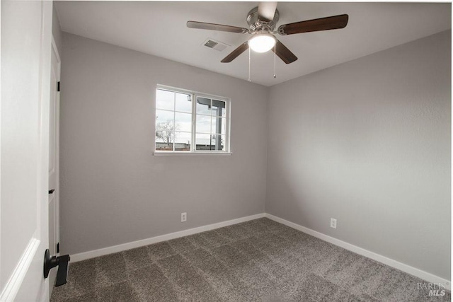 unfurnished room with visible vents, baseboards, ceiling fan, and dark carpet