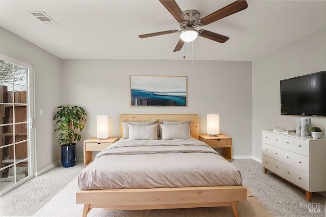 bedroom with visible vents, light carpet, baseboards, and a ceiling fan