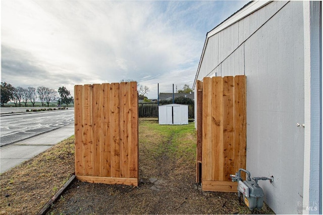 exterior details featuring fence and gas meter