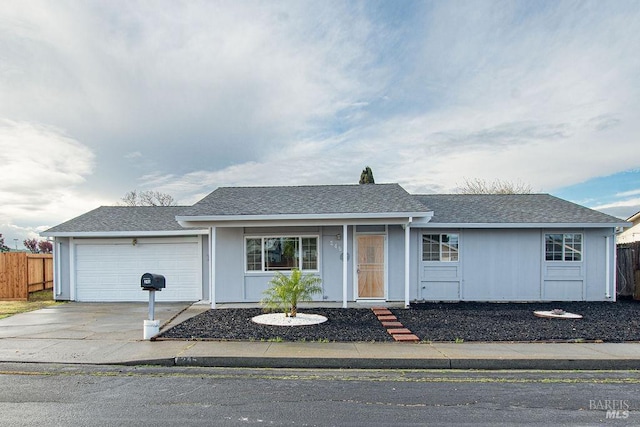 ranch-style house with driveway, an attached garage, roof with shingles, and fence