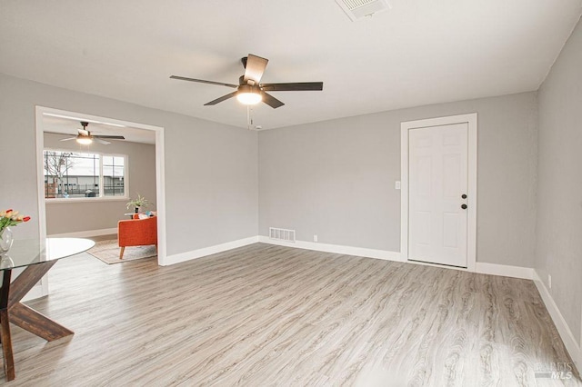 empty room with visible vents, baseboards, and wood finished floors