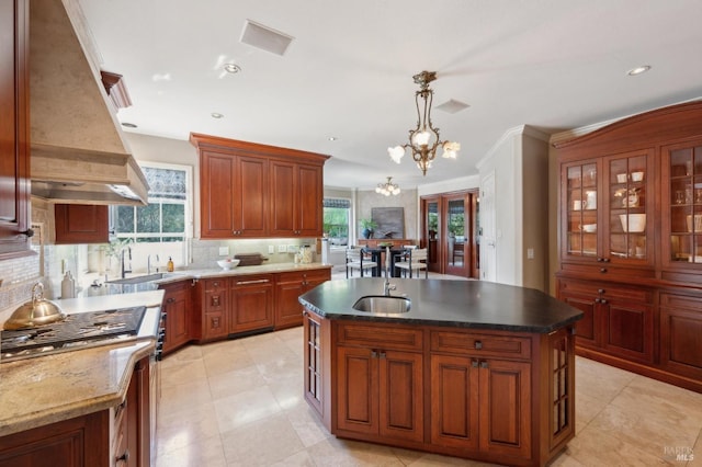 15 Kingswood Dr, Petaluma, CA 94952 - kitchen with premium range hood, stainless steel gas range, decorative backsplash, a chandelier, and a center island with sink