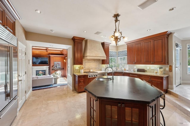 15 Kingswood Dr, Petaluma, CA 94952 - kitchen with premium range hood, high quality fridge, backsplash, a center island with sink, and recessed lighting
