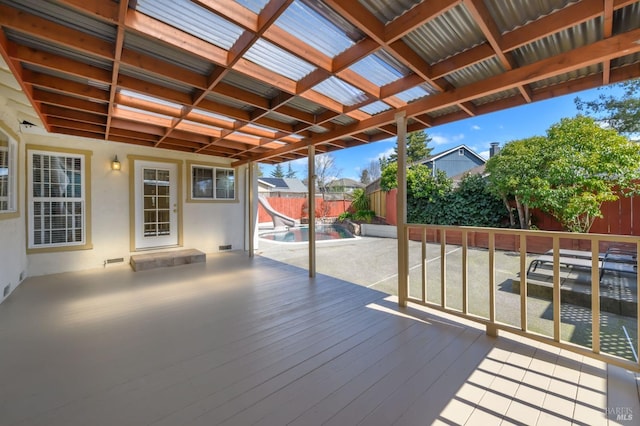 wooden deck with a patio and a fenced backyard