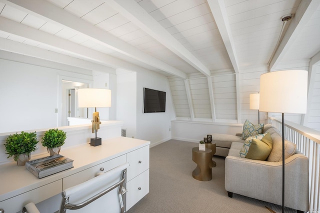 carpeted living area featuring baseboards and beam ceiling