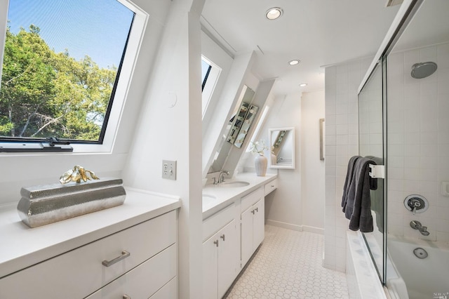 bathroom featuring double vanity, recessed lighting, a sink, tile patterned floors, and tiled shower / bath