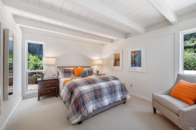 carpeted bedroom featuring beam ceiling, visible vents, and baseboards