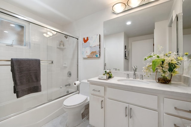 bathroom featuring vanity, tile patterned floors, toilet, and combined bath / shower with glass door