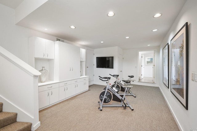 workout area with recessed lighting, light colored carpet, baseboards, and visible vents