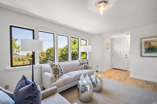 living room featuring light wood-type flooring and baseboards