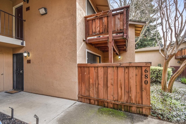 exterior space featuring stucco siding and a balcony