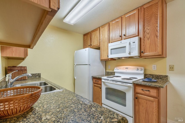 kitchen featuring a sink and white appliances