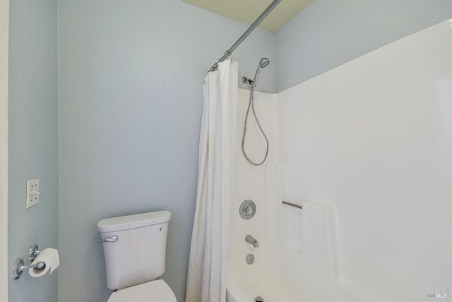 full bathroom featuring toilet and shower / bathtub combination with curtain