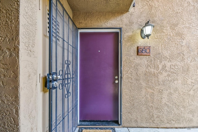 view of exterior entry with stucco siding