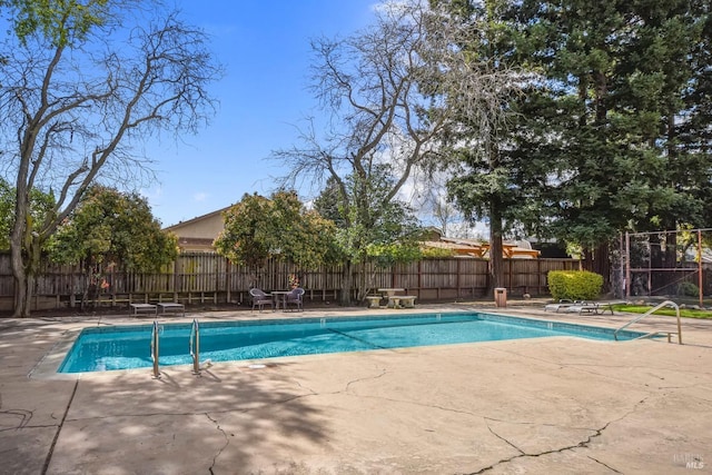 view of swimming pool featuring a patio area, a fenced in pool, and a fenced backyard