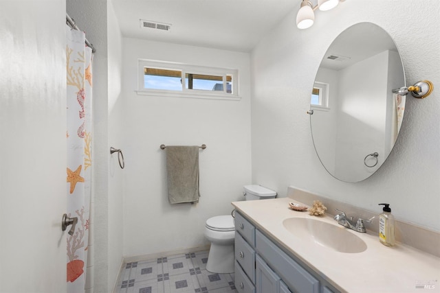 bathroom featuring tile patterned floors, visible vents, toilet, and vanity