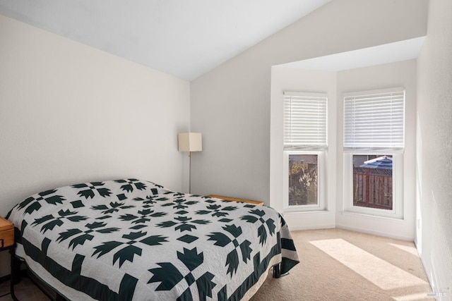 bedroom with lofted ceiling and carpet floors