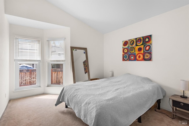 carpeted bedroom with vaulted ceiling