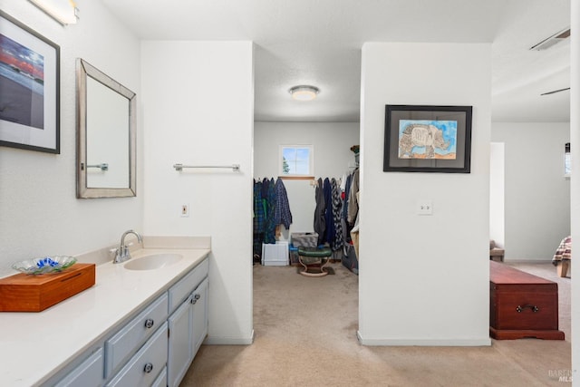 bathroom with vanity and baseboards