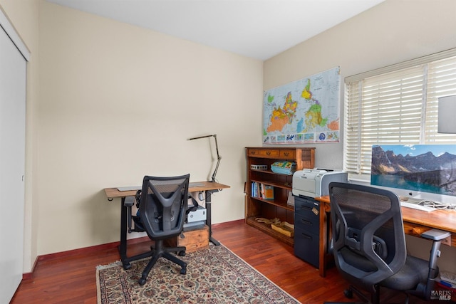 home office featuring baseboards and dark wood-type flooring