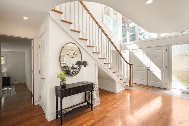 foyer entrance with recessed lighting, baseboards, stairs, and hardwood / wood-style flooring