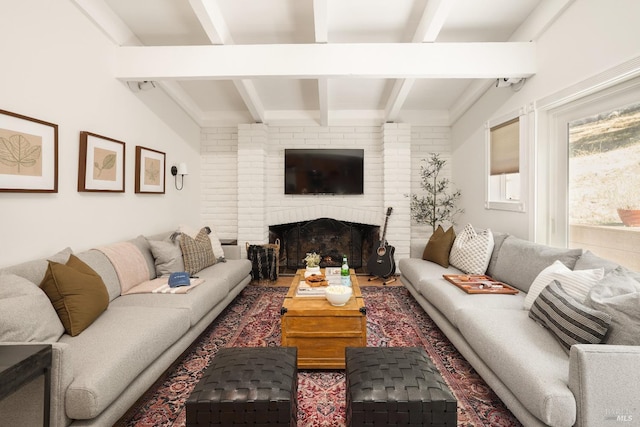 living room with beam ceiling and a brick fireplace